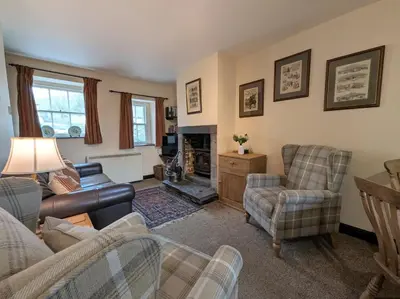 a living room with a couch and chairs and a fireplace at 2 Bed in Cockermouth oc-sz136 in Lorton