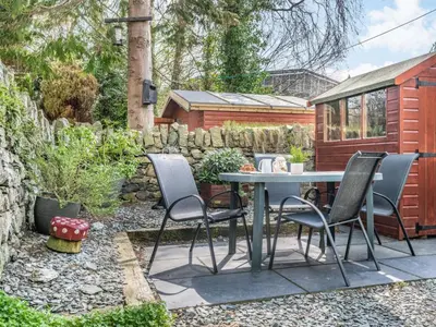 a patio with a table and chairs in a garden at 3 Bed in Keswick SZ395 in Keswick