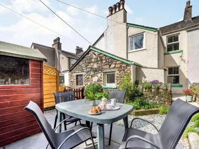a patio with a table and chairs and a building at 3 Bed in Keswick SZ395 in Keswick