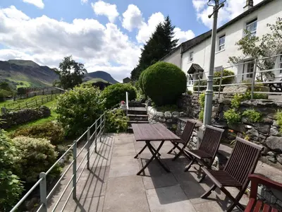 a wooden table and chairs sitting on a patio at 3 Bed in Newlands Valley SZ075 in Borrowdale Valley