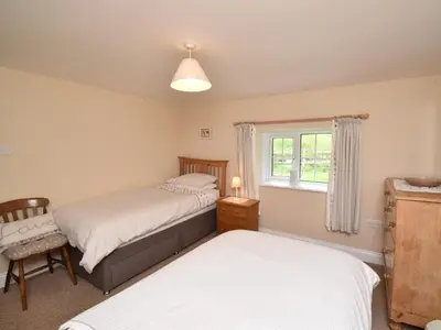 a bedroom with two beds and a window at 3 Bed in Newlands Valley SZ075 in Borrowdale Valley
