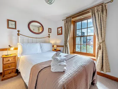 a bedroom with a bed with towels on it at 1 Bed in Keswick SZ472 in Keswick