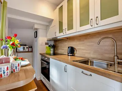 a kitchen with white cabinets and a sink at 1 Bed in Keswick SZ472 in Keswick