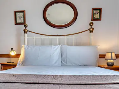 a bedroom with a white bed with a large mirror at 1 Bed in Keswick SZ472 in Keswick