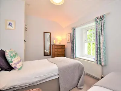 a bedroom with a bed and a window at 4 Bed in Keswick oc-sz434 in Applethwaite