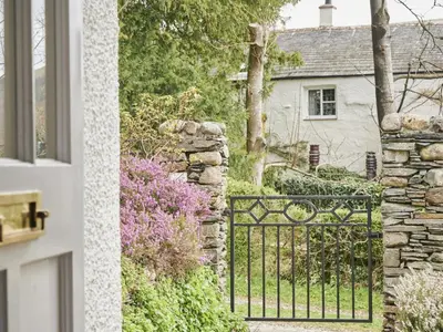 a gate in front of a house with flowers at 4 Bed in Keswick oc-sz434 in Applethwaite