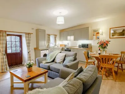 a living room with a couch and a table at 2 Bed in Penrith oc-sz339 in Watermillock