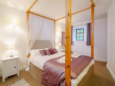 a bedroom with a four poster bed with a canopy at 2 Bed in Penrith oc-sz339 in Watermillock