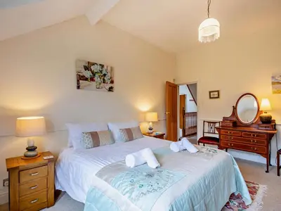 a bedroom with a bed and a dresser and a mirror at 3 Bed in Keswick oc-sz135 in Threlkeld