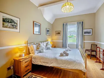 a bedroom with a bed with a dresser and a window at 3 Bed in Keswick oc-sz135 in Threlkeld