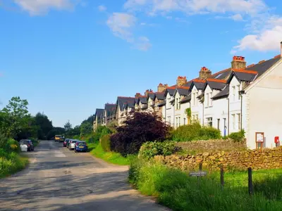 a row of houses on the side of a road at 3 Bed in Keswick oc-sz135 in Threlkeld