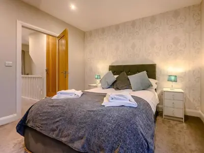 a bedroom with a large bed with towels on it at 2 Bed in Keswick oc-sz036 in Keswick