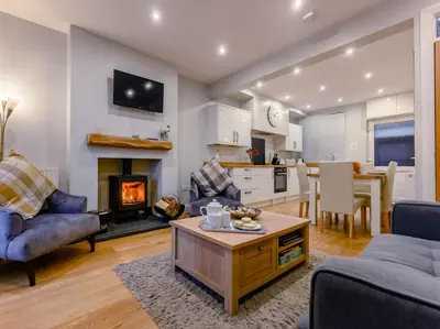 a living room with a couch and a table and a fireplace at 2 Bed in Keswick oc-sz036 in Keswick