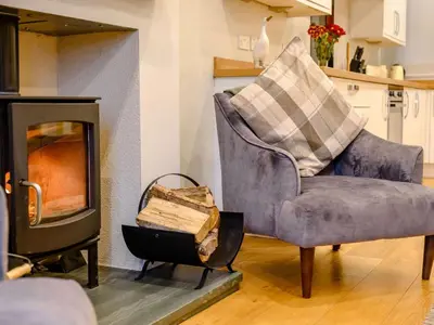 a living room with a chair and a fireplace at 2 Bed in Keswick oc-sz036 in Keswick