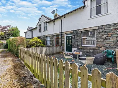 a house with a wooden fence in front of it at 2 Bed in Keswick oc-sz026 in Keswick