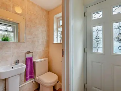 a bathroom with a toilet and a sink and a window at 2 Bed in Keswick oc-sz026 in Keswick