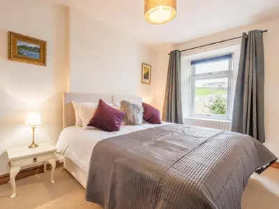 a bedroom with a large bed and a window at 3 Bed in Gosforth oc-sz064 in Gosforth