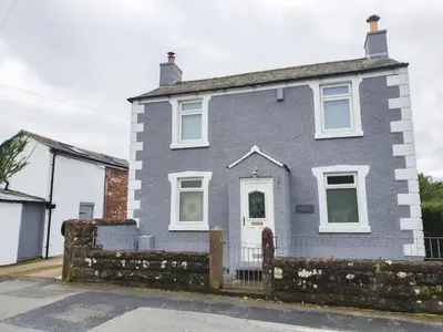a gray house with a fence in front of it at 3 Bed in Gosforth oc-sz064 in Gosforth