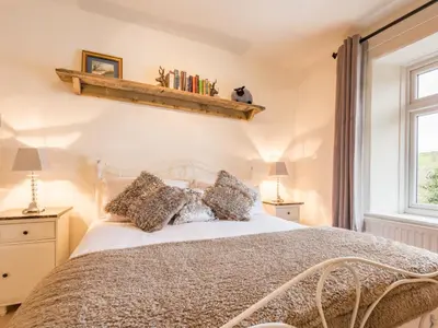 a bedroom with a large bed and a window at 3 Bed in Gosforth oc-sz064 in Gosforth