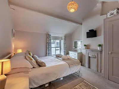 a bedroom with a large bed and a window at 1 Bed in Keswick oc-sz112 in Keswick