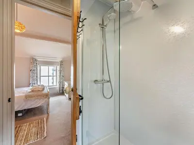 a bathroom with a shower next to a bedroom at 1 Bed in Keswick oc-sz112 in Keswick