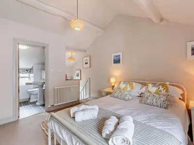 a bedroom with a large bed with pillows on it at 1 Bed in Keswick oc-sz112 in Keswick