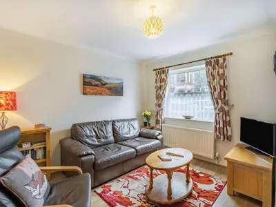 a living room with a leather couch and a tv at 2 Bed in Keswick SZ462 in Keswick