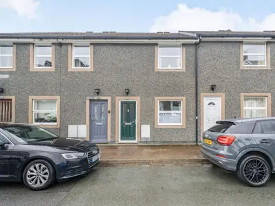 two cars parked in front of a brick house at 2 Bed in Keswick SZ462 in Keswick