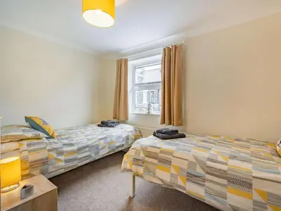 a bedroom with two beds and a window at 2 Bed in Keswick SZ462 in Keswick