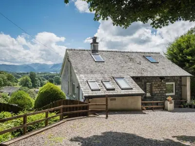 a house with a roof with windows and a fence at 3 Bed in Applethwaite SZ540 in Applethwaite