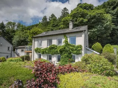 a white house with ivy growing on it at 3 Bed in Applethwaite SZ328 in Applethwaite