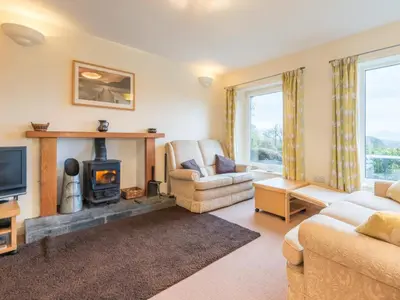 a living room with a fireplace and a couch at 3 Bed in Applethwaite SZ328 in Applethwaite