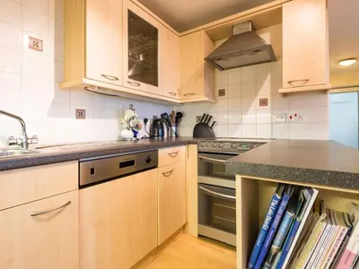 a kitchen with wooden cabinets and a sink at 3 Bed in Applethwaite SZ328 in Applethwaite