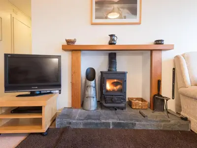 a living room with a fireplace and a tv at 3 Bed in Applethwaite SZ328 in Applethwaite