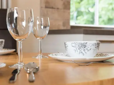 a table with two wine glasses and a cup and saucer at 2 Bed in Keswick SZ379 in Keswick