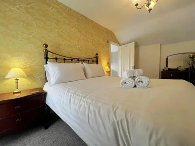 a bedroom with a large white bed with two baskets on it at 2 Bed in Keswick SZ379 in Keswick