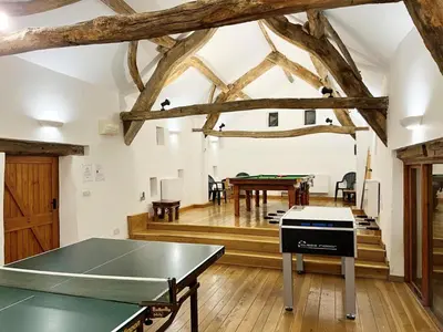 a ping pong table in a room with wooden floors at 4 Bed in Routenbeck SZ405 in Bassenthwaite Lake