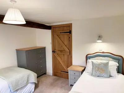 a bedroom with a bed and a wooden door at 4 Bed in Routenbeck SZ405 in Bassenthwaite Lake