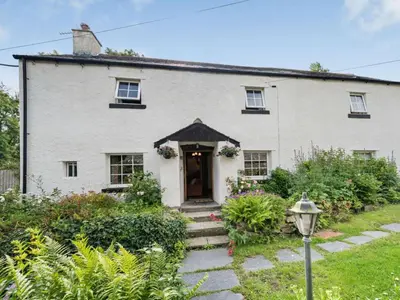 an old white house with a door and stairs at 4 Bed in Routenbeck SZ405 in Bassenthwaite Lake