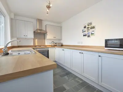 a kitchen with white cabinets and a sink at 4 Bed in Keswick oc-sz443 in Keswick