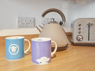 three coffee mugs sitting on a counter with a tea kettle at 4 Bed in Keswick oc-sz443 in Keswick