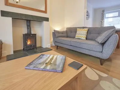 a living room with a couch and a fireplace at 4 Bed in Keswick oc-sz443 in Keswick