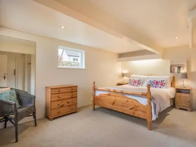 a bedroom with a bed and a chair and a window at 3 Bed in Keswick oc-sz194 in Braithwaite