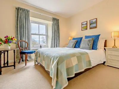 a bedroom with a bed and a desk and a window at 4 Bed in Penrith oc-sz367 in Dockray