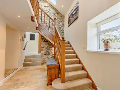 a staircase in a home with a stone wall at 4 Bed in Penrith oc-sz367 in Dockray