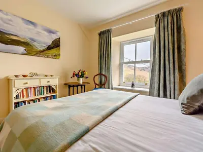 a bedroom with a large bed and a window at 4 Bed in Penrith oc-sz367 in Dockray