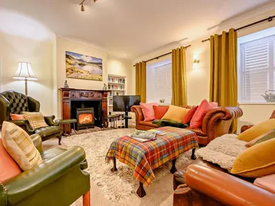 a living room filled with furniture and a fireplace at 4 Bed in Penrith oc-sz367 in Dockray