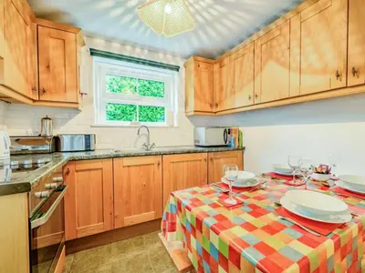 a kitchen with a table with plates and wine glasses at 2 Bed in Borrowdale SZ302 in Rosthwaite