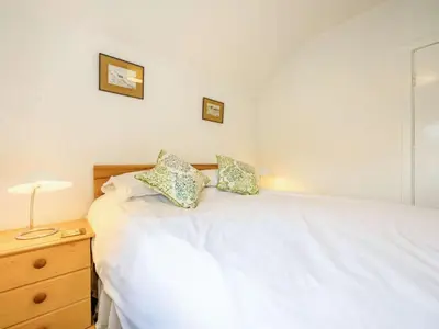 a bedroom with a white bed with two pillows on it at 2 Bed in Borrowdale SZ302 in Rosthwaite