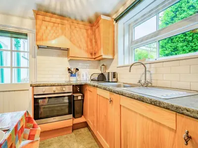 a kitchen with wooden cabinets and a sink at 2 Bed in Borrowdale SZ302 in Rosthwaite